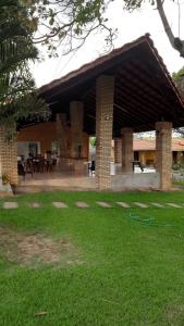 a pavilion with a table and chairs in the grass at Pousada do Rancho in Barreirinhas