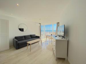 a living room with a couch and a table at Paradiso Aparthotel - Private apartment -BSR-2 in Nesebar