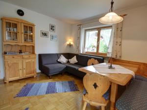 a living room with a couch and a table at Beim Wirtschmied - Chiemgau Karte in Inzell