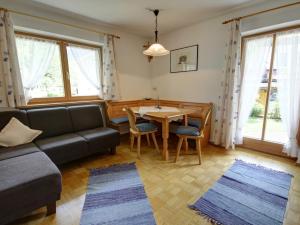 a living room with a couch and a table at Beim Wirtschmied - Chiemgau Karte in Inzell