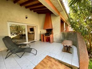 a patio with a chair and a table at Liflosa in Lecci