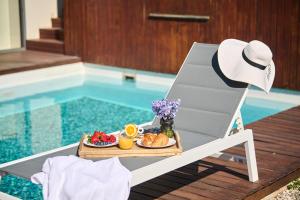 a tray of food on a chair next to a pool at Villa Frida in Zambratija +48 photos