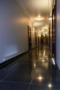 a hallway of a building with a tile floor and lights at Lwów in Chełm