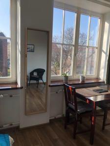 a mirror in a room with a table and a chair at Apartament Teatralny in Gdańsk