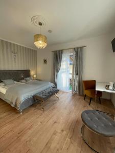 a bedroom with a bed and a table and a desk at Boutique Haus Sissi in Füssen +127 photos