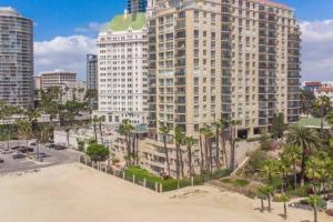 an aerial view of a large building with palm trees at Oceanfront lux condo in Long Beach