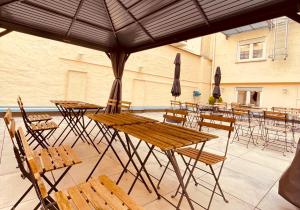 a group of tables and chairs under an umbrella at Hotel Moguntia in Mainz