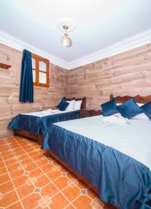 Postel nebo postele na pokoji v ubytování Hotel Al kassaba