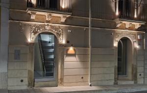 a building with a staircase on the side of it at Miramare rooms b&b in Avola