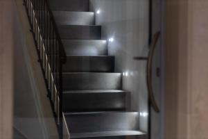 a set of stairs in a hallway with lights at Miramare rooms b&b in Avola