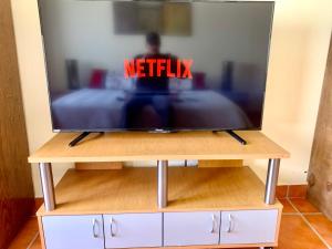a television on a tv stand with the words netflix at Casa Fraile San Miguel in San Miguel de Allende