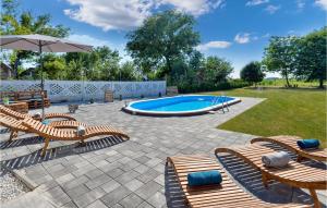 a patio with chairs and a swimming pool at Awesome Home In Svibovec Podravski With Kitchen in Svibovec Podravski