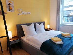 a bedroom with a bed with two pillows on it at M-OASE Wohlfühlen an der Oker I Küche I Netflix in Braunschweig