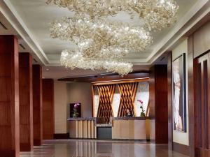 a lobby with chandeliers hanging from the ceiling at The Royal Sonesta Houston Galleria in Houston