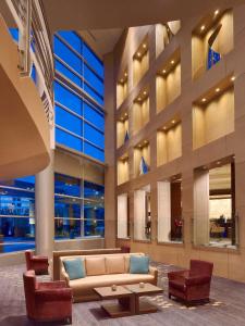 a lobby of a building with a couch and chairs at The Royal Sonesta Houston Galleria in Houston