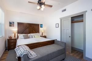 a bedroom with a bed and a couch and a ceiling fan at El Capitan Loft in Yosemite West