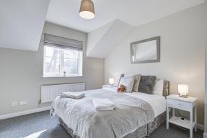 a bedroom with a large bed and a window at Windsor Burnham Ascot Haven Sleeps 4 in Slough