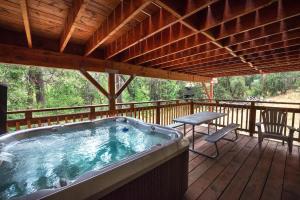 a hot tub on the deck of a cabin at Sierra Springs in Oakhurst