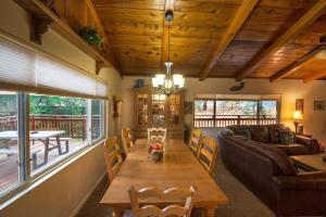a living room with a wooden table and a couch at Sierra Springs in Oakhurst