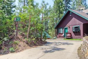 a red house with a street sign in front of it at Yosemite Pines in Yosemite West