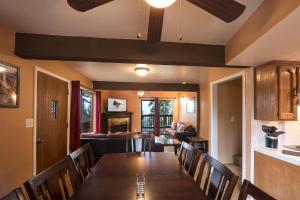 a dining room with a long table and chairs at Yosemite Aviary in Yosemite West