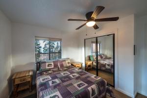 a bedroom with a bed and a ceiling fan at Yosemite Aviary in Yosemite West