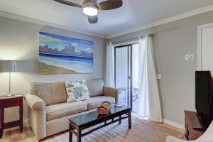 a living room with a couch and a tv at Sands Village #B-3B in Hilton Head Island