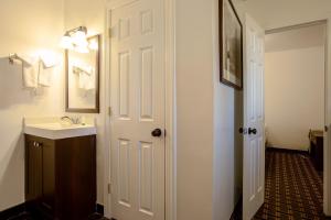 a bathroom with a sink and a white door at Star Route 66 Grand Canyon in Williams