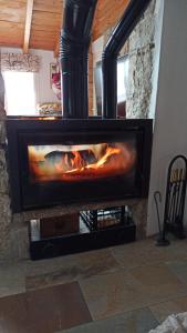 a fireplace with a fire in it in a room at La Consentida in La Cabrera