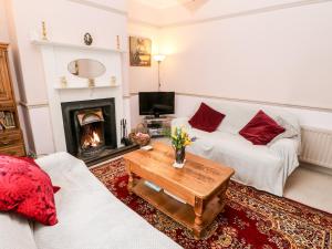 a living room with a couch and a fireplace at Cosy Nook in Alnwick