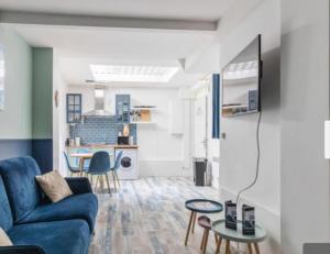 a living room with a blue couch and a table at LE MARAIS-SAINT MARTIN LUXURY & DESIGN BY STUDIO in Paris