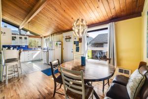 a kitchen and dining room with a wooden ceiling at The Lily Pad in Rockaway Beach +19 photos