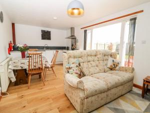 a living room with a couch and a table at The Barn in High Catton