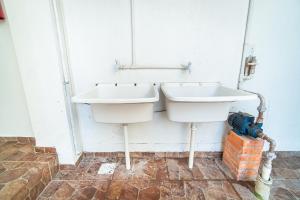 a bathroom with a sink and a mirror on the wall at Parada da Cal Beach Torres in Torres +19 photos