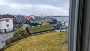 a view from a window of a city with grass roofs at Downtown - Jørgen Frantz - Marina in Tórshavn