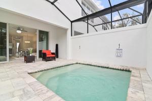 a swimming pool in the backyard of a house at New Cozy & Spacious Townhouse near Disney - 4BR, 3FB, and Pool in Orlando