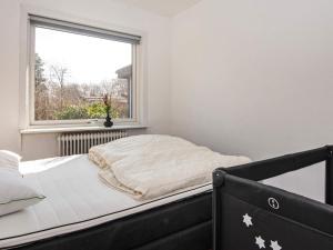 a bed in a room with a window at 6 person holiday home in Nørre Nebel-By Traum in Nørre Nebel