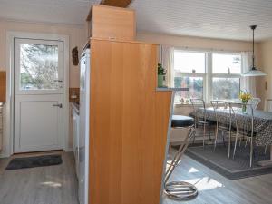 a kitchen and dining room with a table and chairs at 6 person holiday home in Henne in Henne Strand
