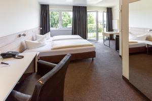 Säng eller sängar i ett rum på Trend Hotel