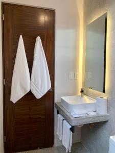 a bathroom with a sink and a mirror at Las Palmas Studios in Cancún