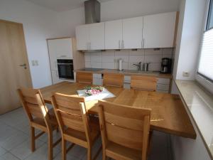 a kitchen with a wooden table and chairs at Holiday home Wiesenblick in Dobbertin in Dobbertin