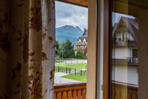 a view of a mountain from a window at Apartamenty i pokoje gościnne Nowita in Zakopane