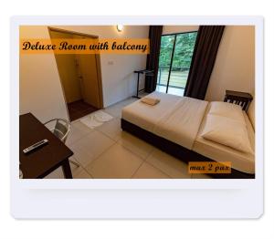 a bedroom with a bed and a table and a desk at RIVERSIDE PALM INN SG LEMBING in Sungai Lembing