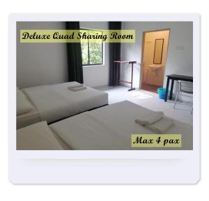 a room with two beds and a piano in it at RIVERSIDE PALM INN SG LEMBING in Sungai Lembing