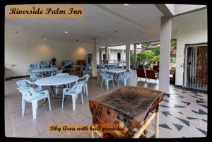a dining room with tables and chairs and a table at RIVERSIDE PALM INN SG LEMBING in Sungai Lembing +31 photos