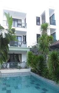 ein Hotel mit einem Pool vor einem Gebäude in der Unterkunft Starfruit Villa in Hoi An
