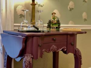 un tavolo di legno con due bicchieri sopra di Charlotte's Rose Inn a Charlottetown