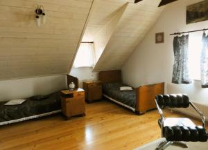 a attic room with two beds and a staircase at Apartment Tagrajska in Ljubljana