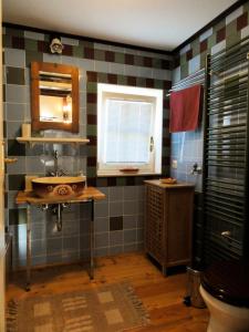 a bathroom with a sink and a mirror and a window at Apartment Tagrajska in Ljubljana