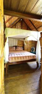 a bedroom with a bed in a wooden house at hostal Monte Libano in Puerto López